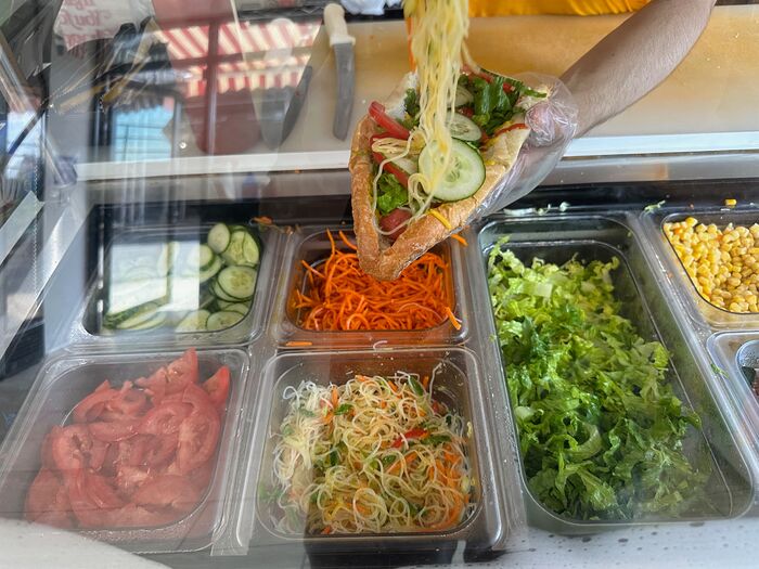 2025 - 07 - 25 - Toshkent Hot Dog next the cucumbers and noodles